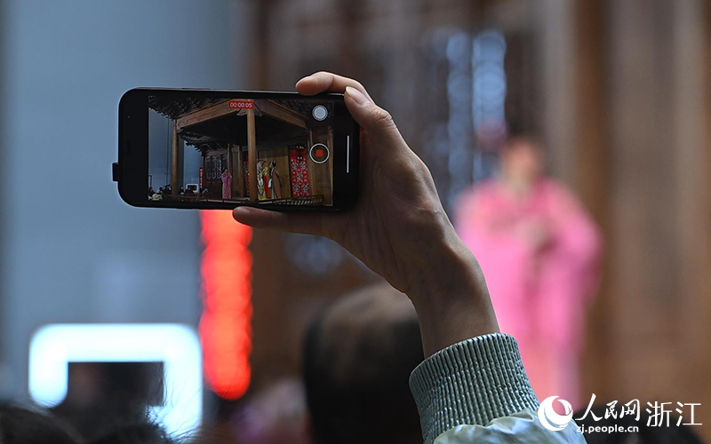 觀眾用手機拍攝下越劇表演。