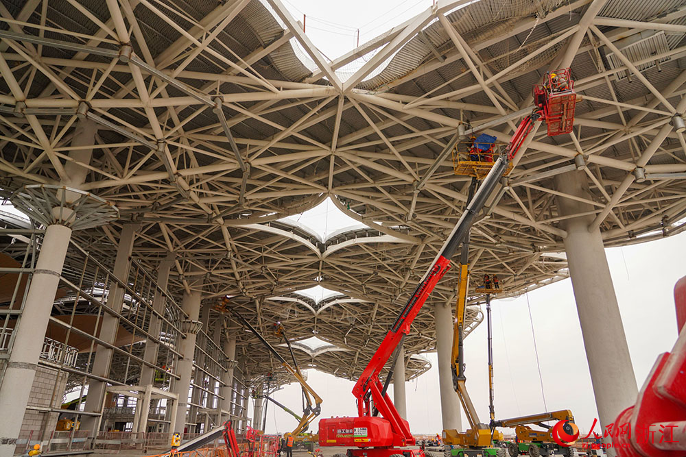工人們開足馬力搶工期、趕進度，呈現一派火熱景象。人民網 章勇濤攝